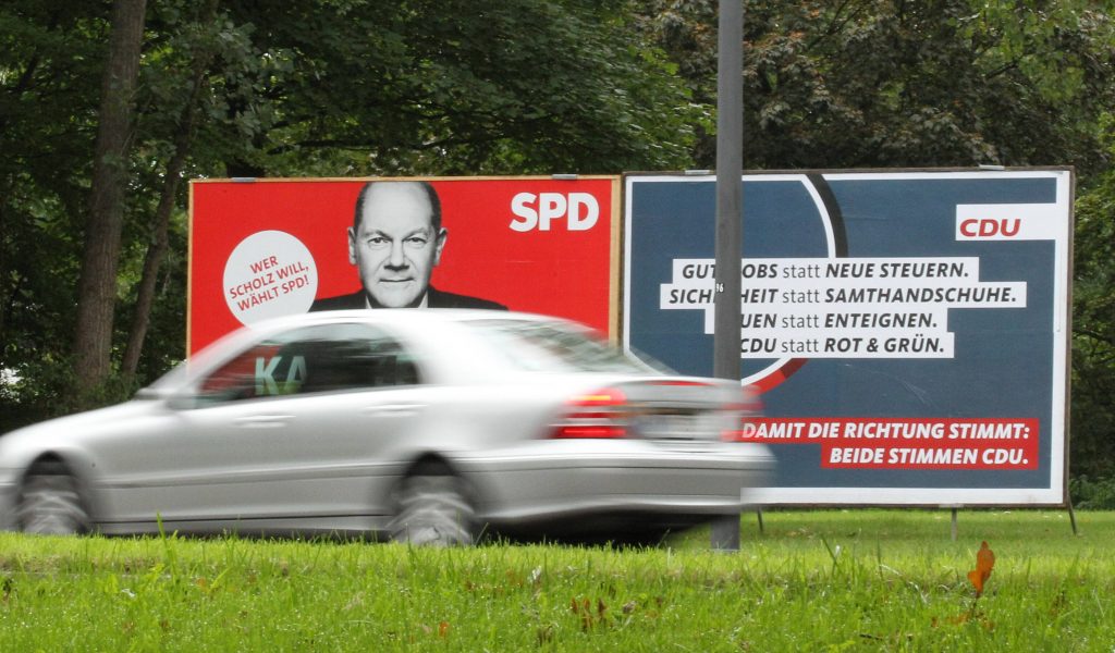 Ein Wahlplakat der SPD mit dem Konterfei von Kanzlerkandidat Olaf Scholz steht neben einem Wahlplakat der CDU an einer Straße in Barmbek.