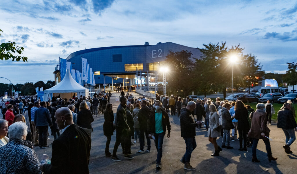Besucher des Konzerts von Roland Kaiser stehen in langen Schlangen an Kontrollstellen vor der Barclays Arena