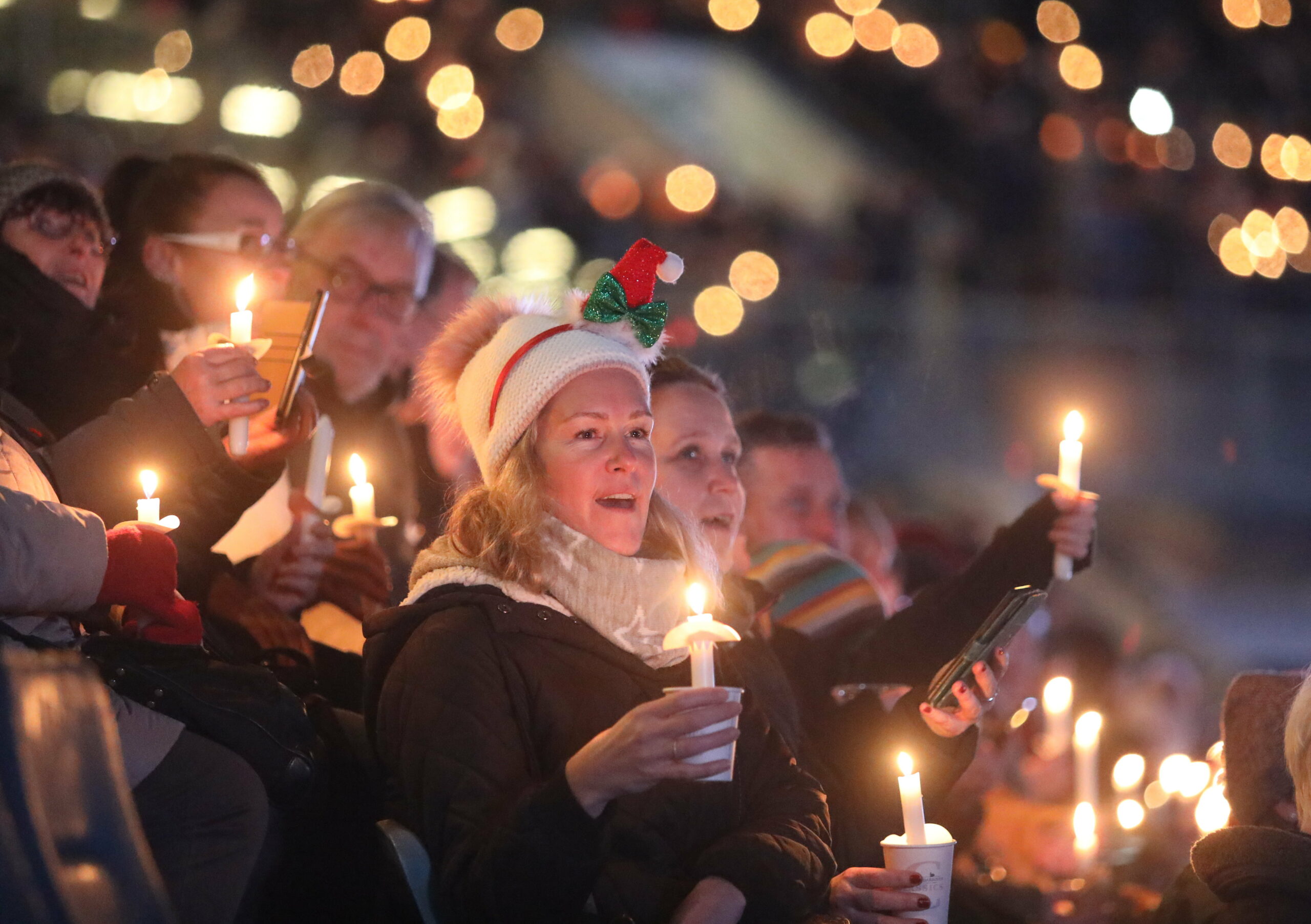 Menschen nehmen beim Weihnachtssingen im Ostseestadion teil