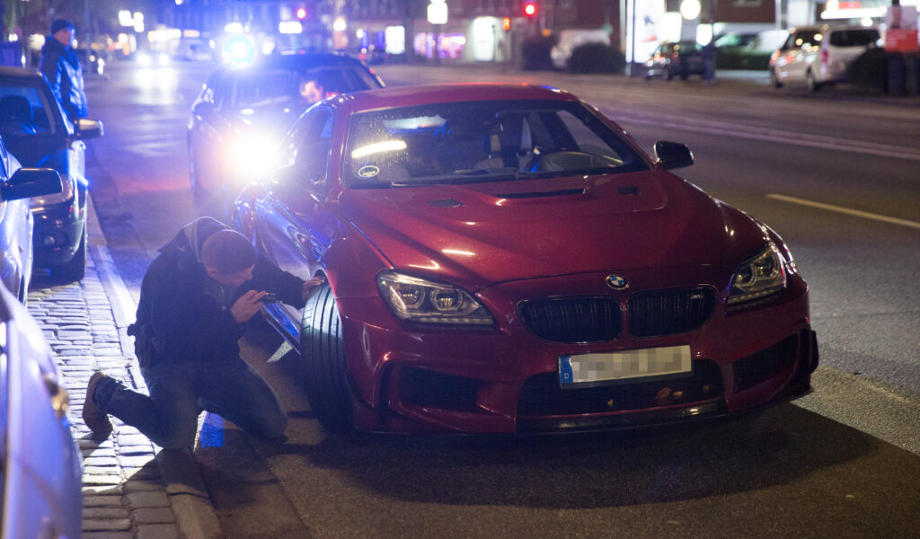 Hamburger Polizisten untersuchen des Wagen eines Auotposers.